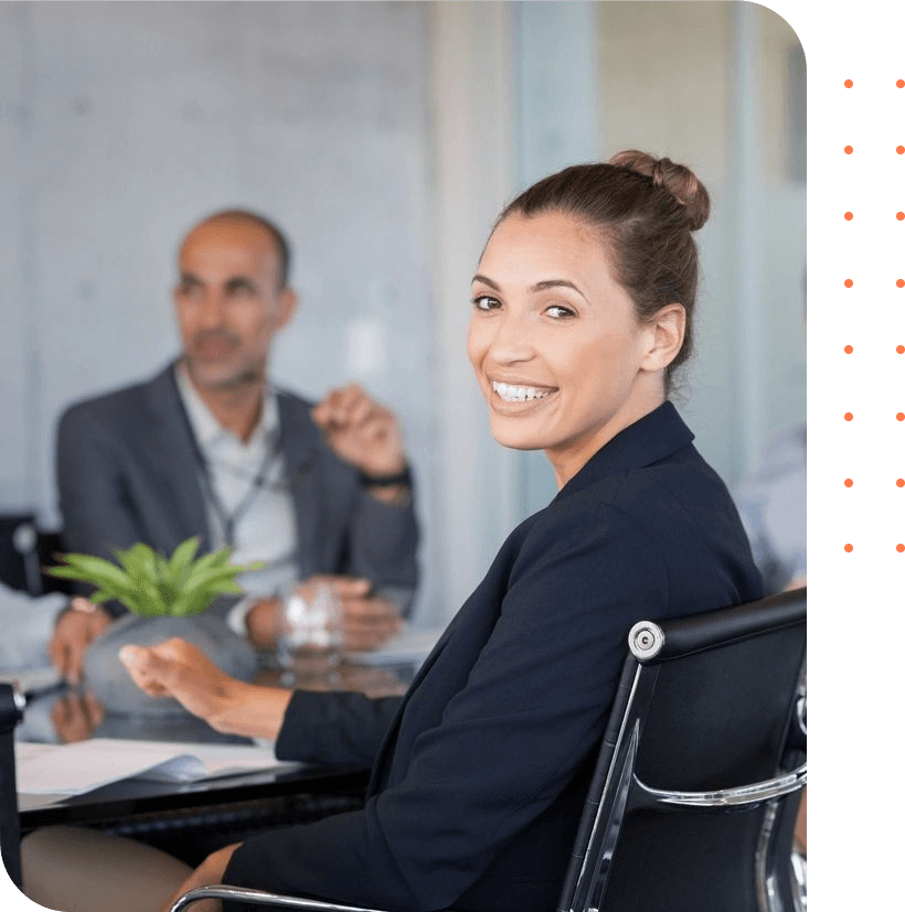 Proud smiling business woman sitting during a meeting and looking at camera