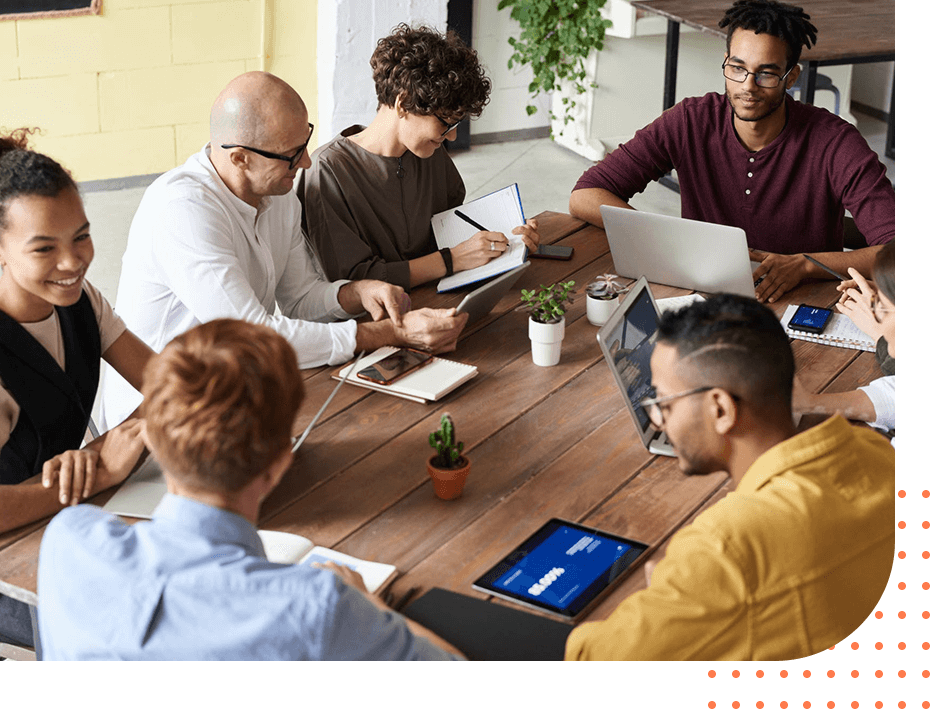 Group of young modern people in smart casual wear discussing business while sitting in the creative office