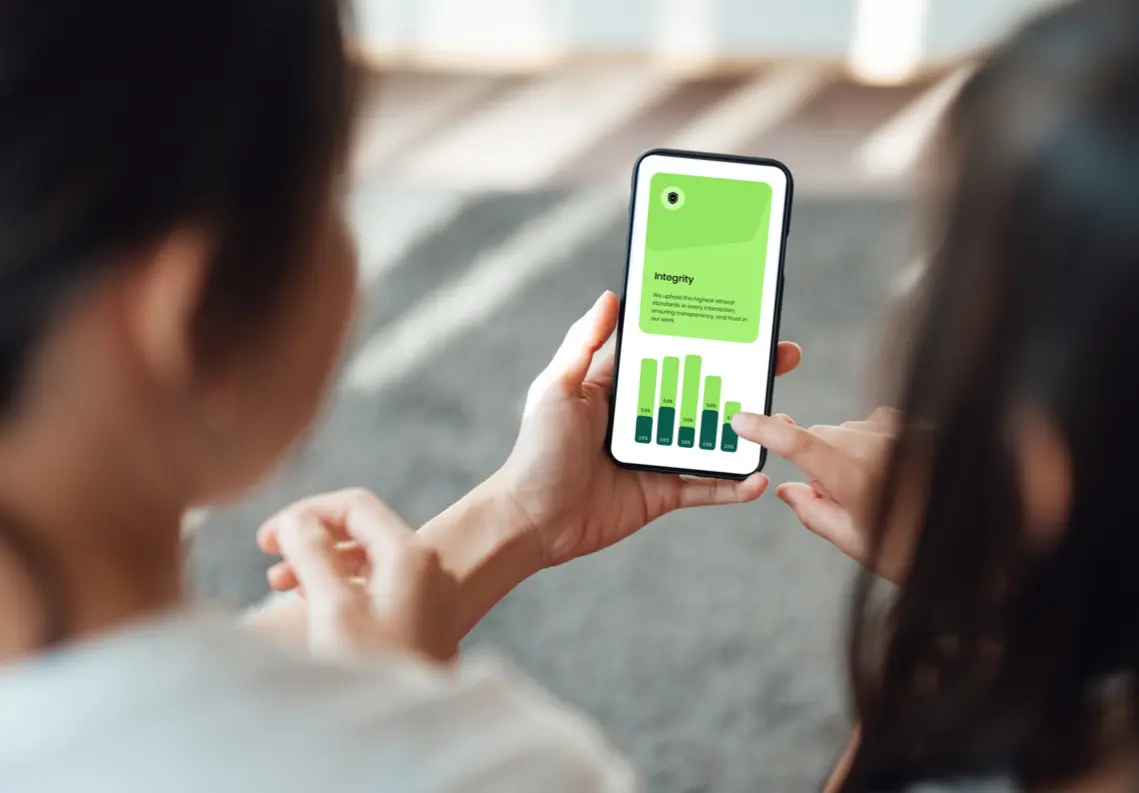 Two people looking at phone graphs.
