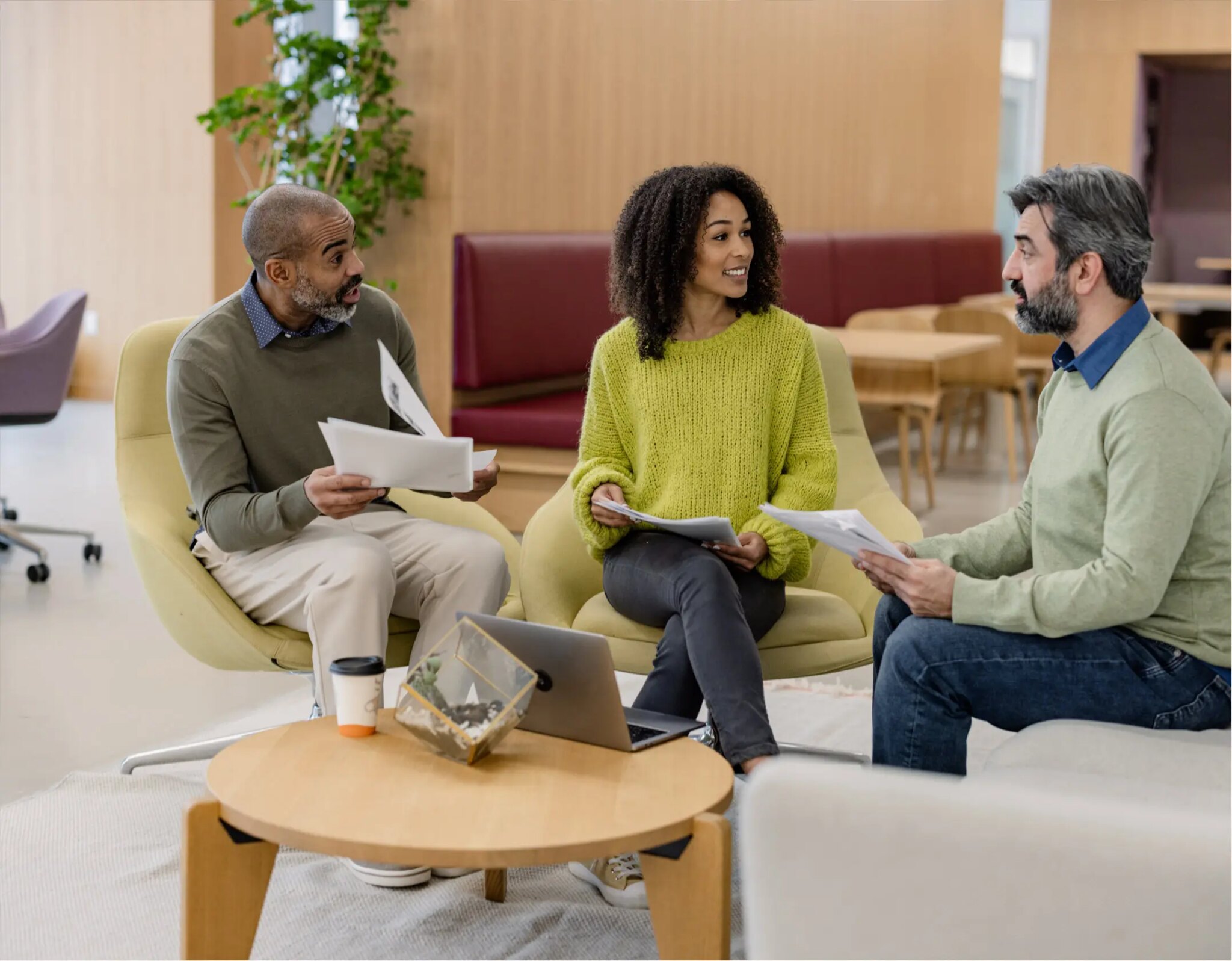 Three people having a business meeting together.