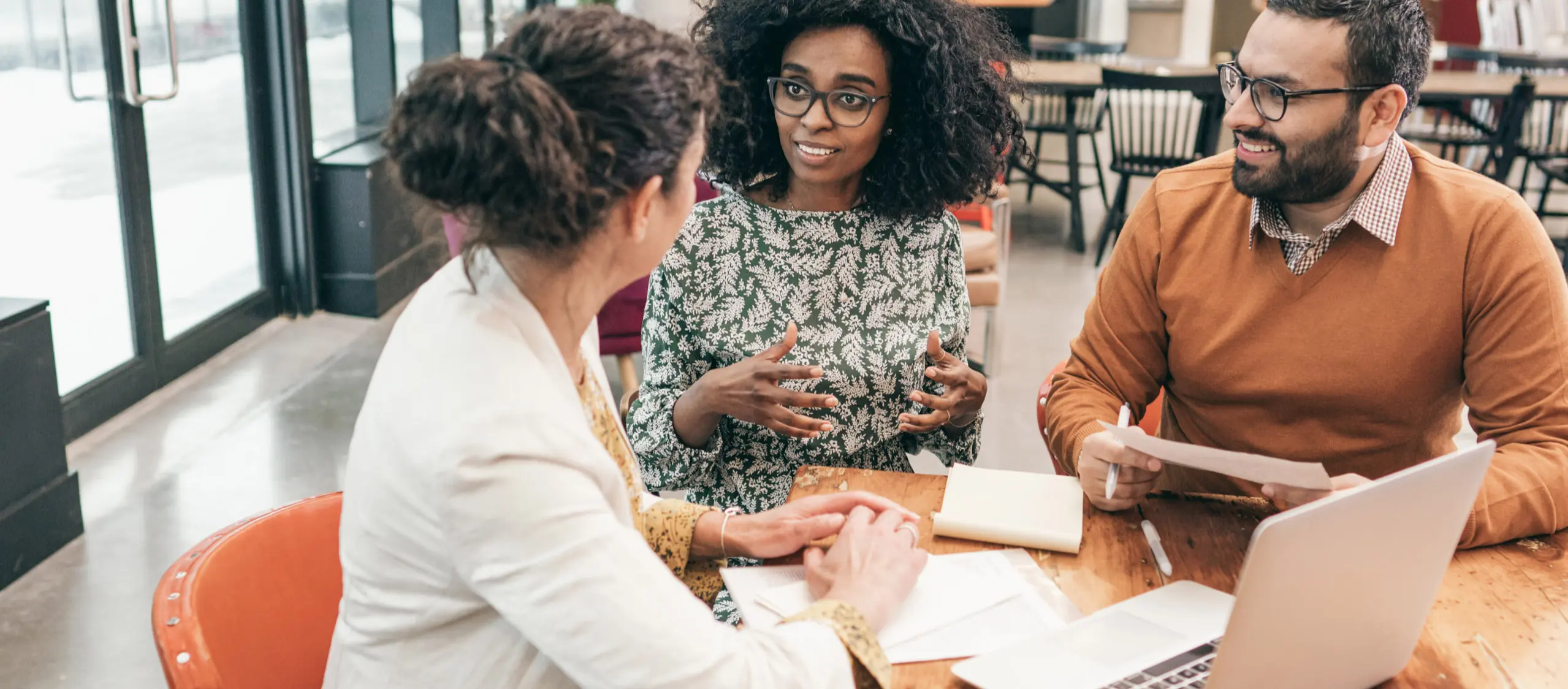 Three people having a business meeting.