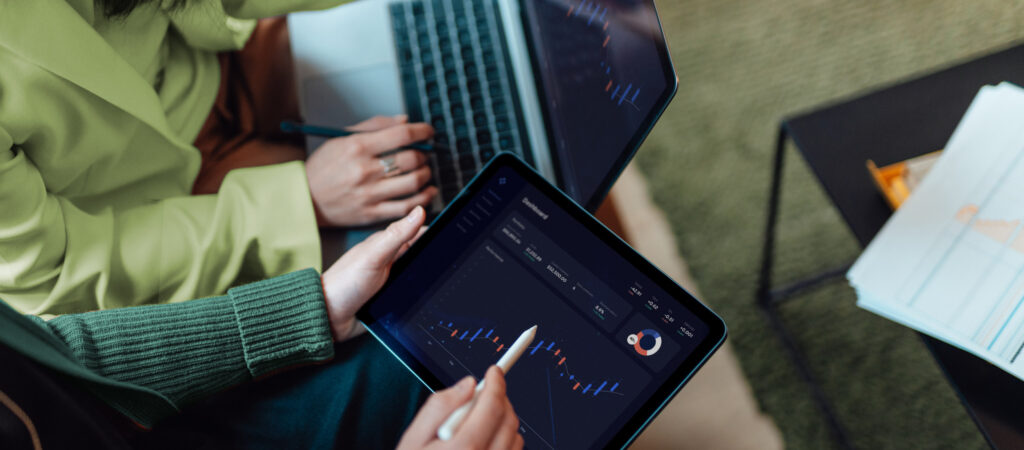 Two people analyzing data on devices.