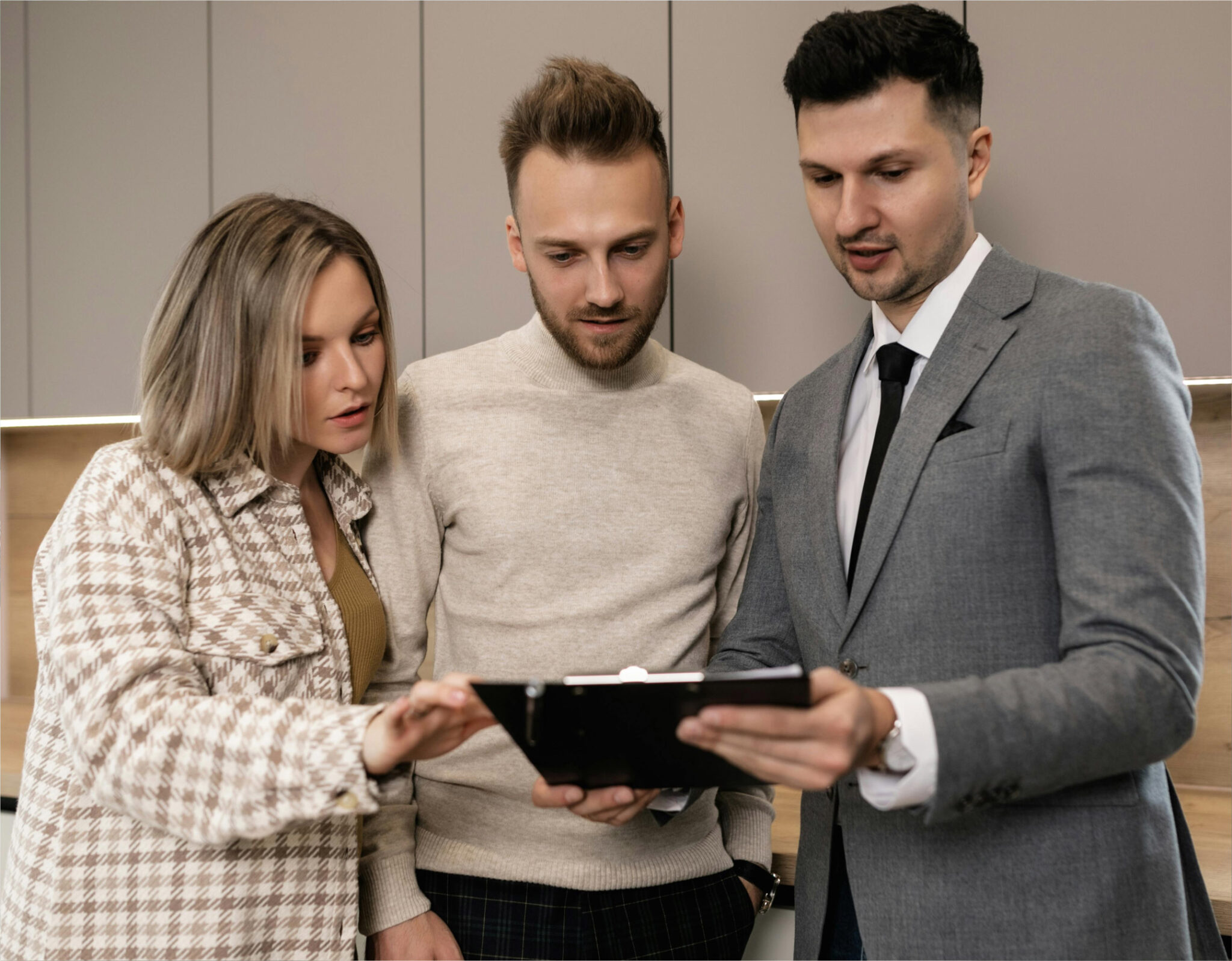 Three people reviewing a document together.