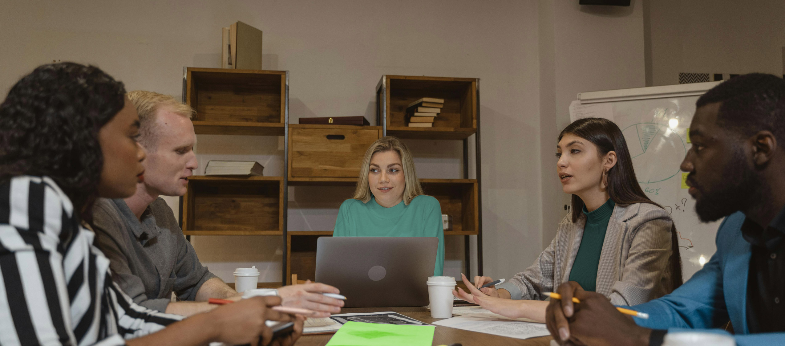 Team meeting around a table discussing ideas.