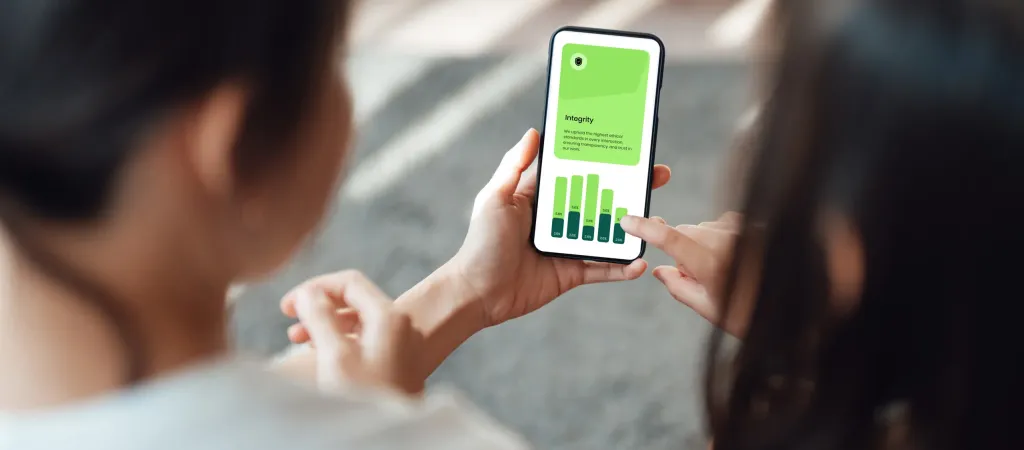 Hands holding phone displaying green bar chart