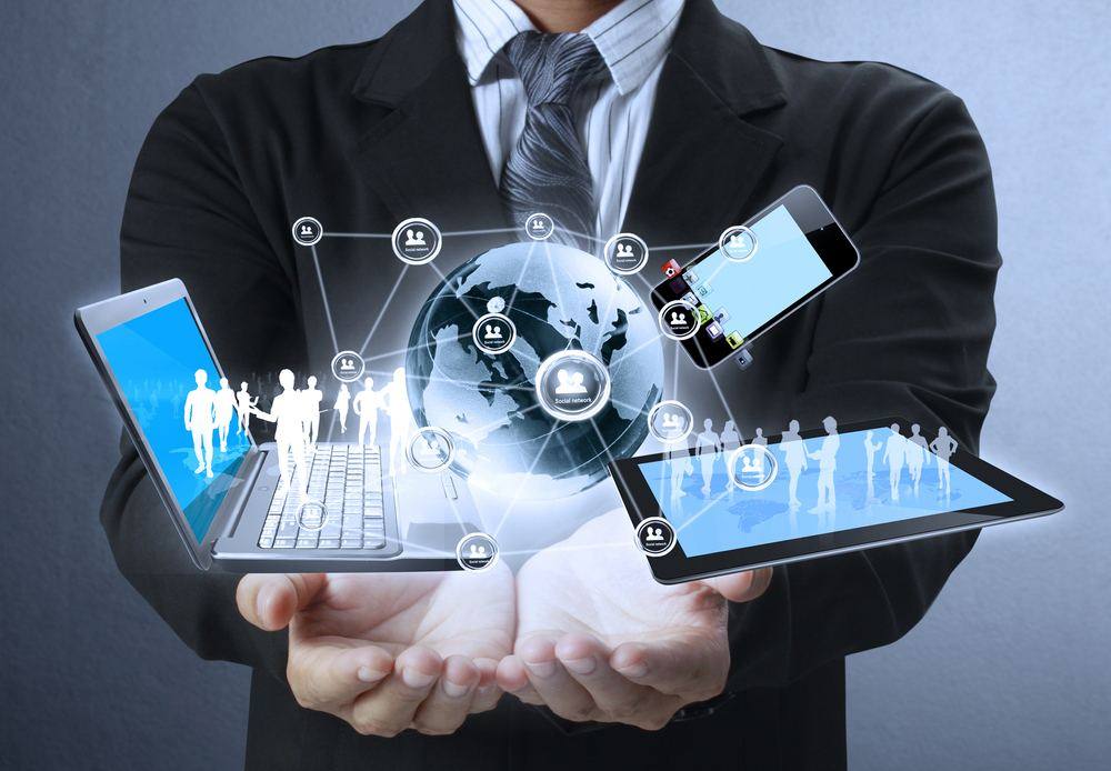 Businessman showing holographic globe with devices