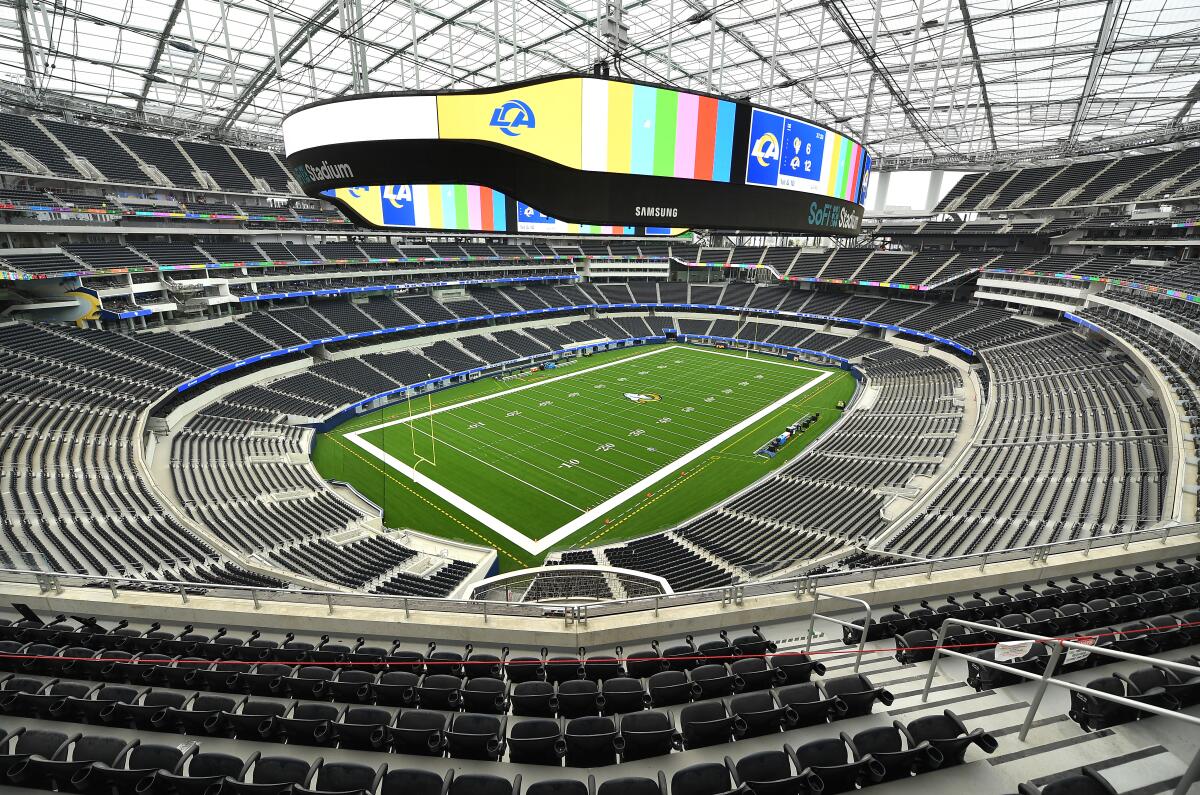 Empty football stadium with large digital screen.