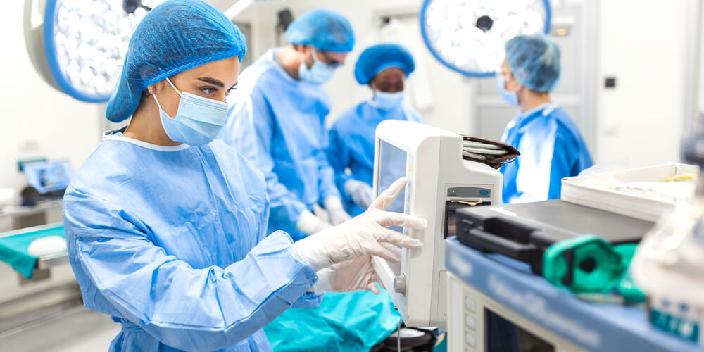 Surgeons in operating room checking medical equipment.