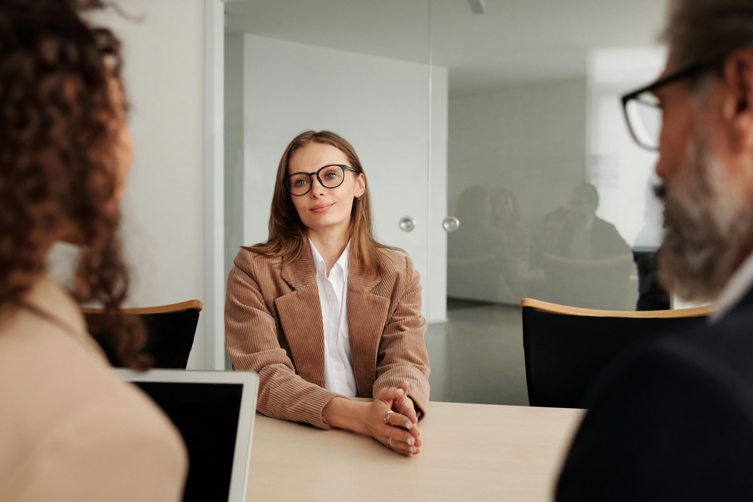 Woman in meeting with two colleagues.