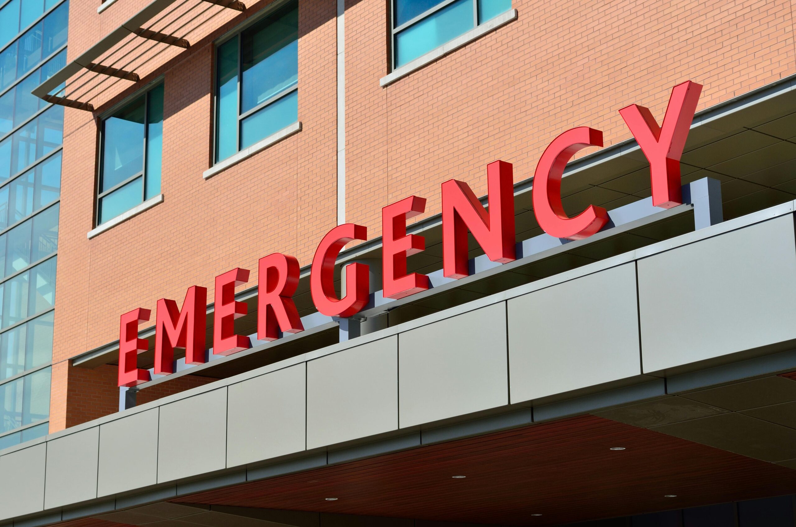 Emergency entrance sign on hospital building.