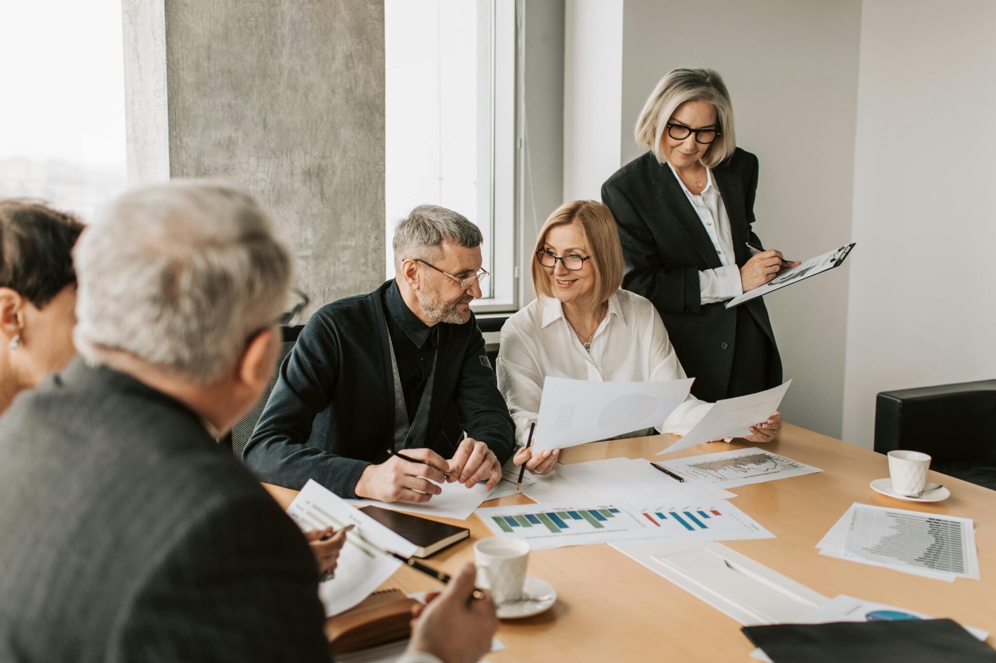 Business meeting with people reviewing documents.