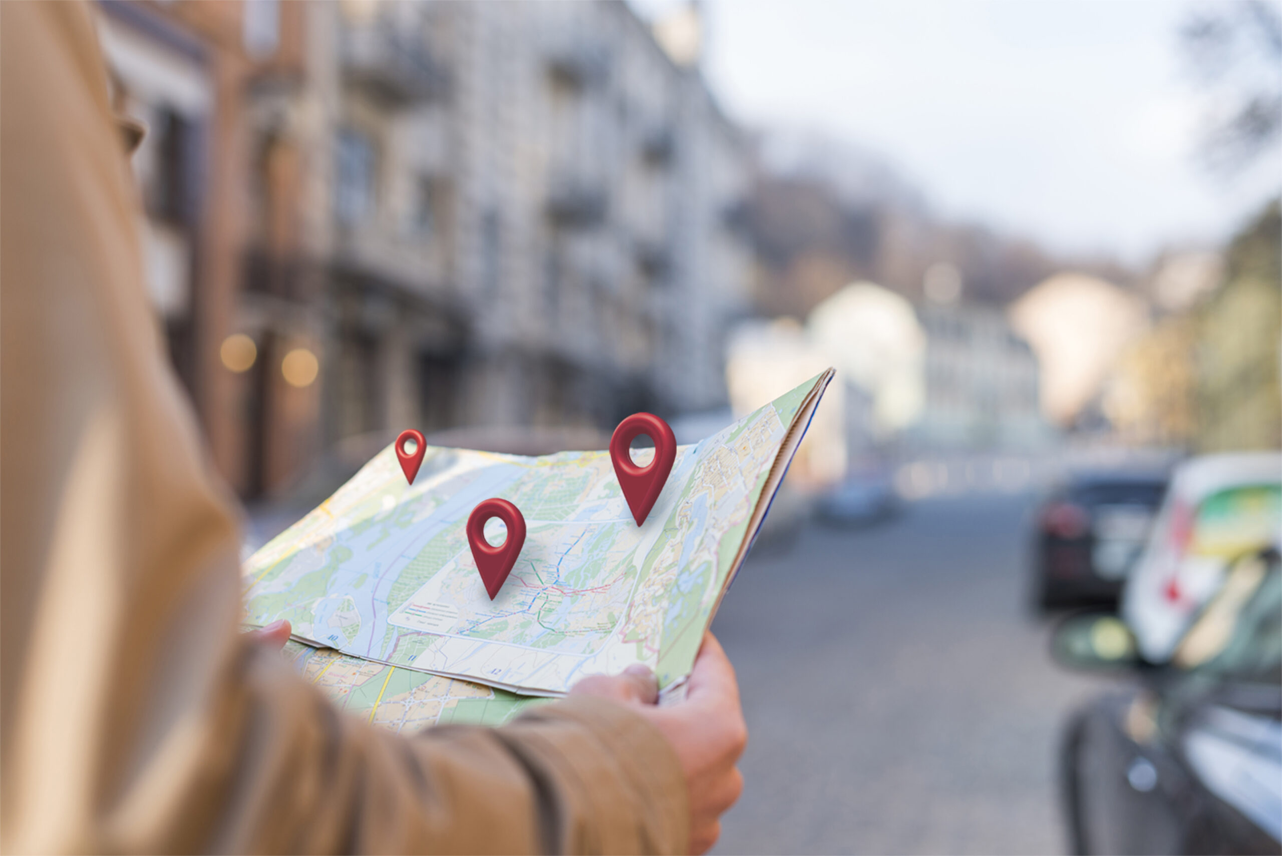 Person holding map with location markers.